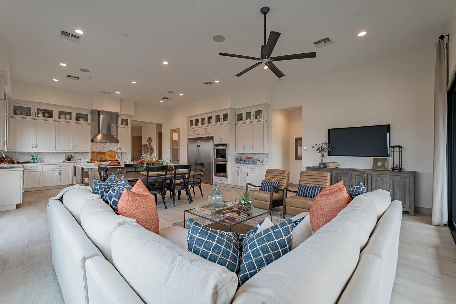 The open great room and kitchen of a finished Capital West move-in-ready home
